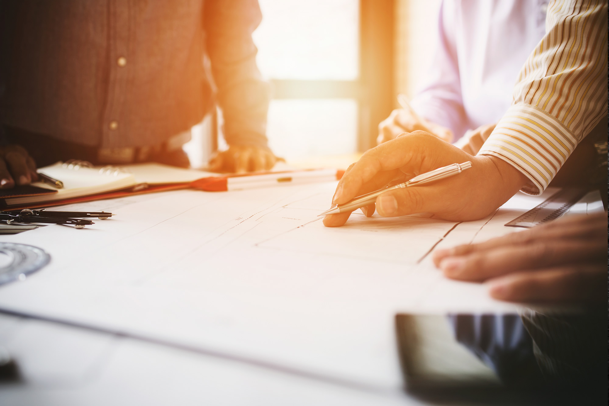 Image of Consultation between colleagues, engineering team to check the blueprint.